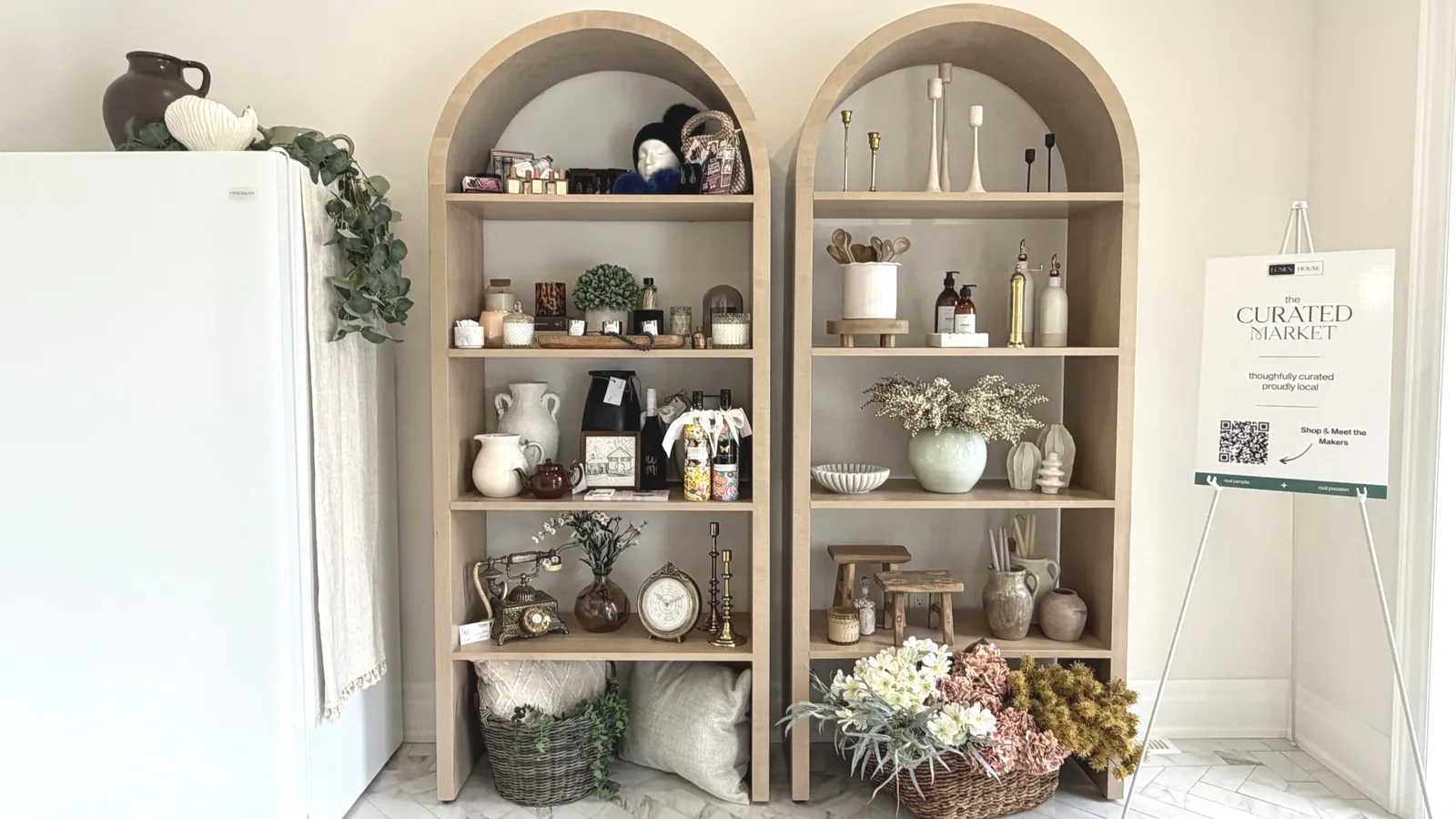 Arched shelves of the Curated Market styled with local makers' goods