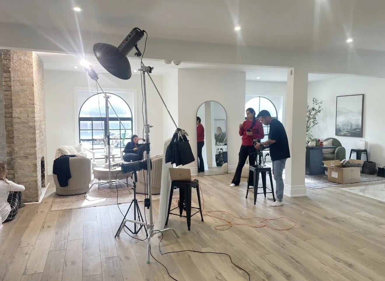 A photographer and team setting up lighting for a shoot at Lumen House