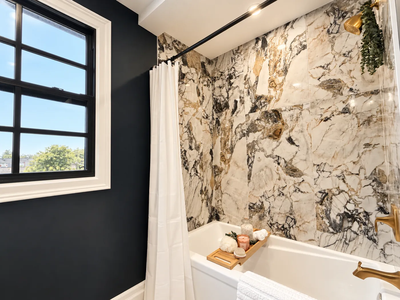Statement bathroom with marble-look tile and soaker tub